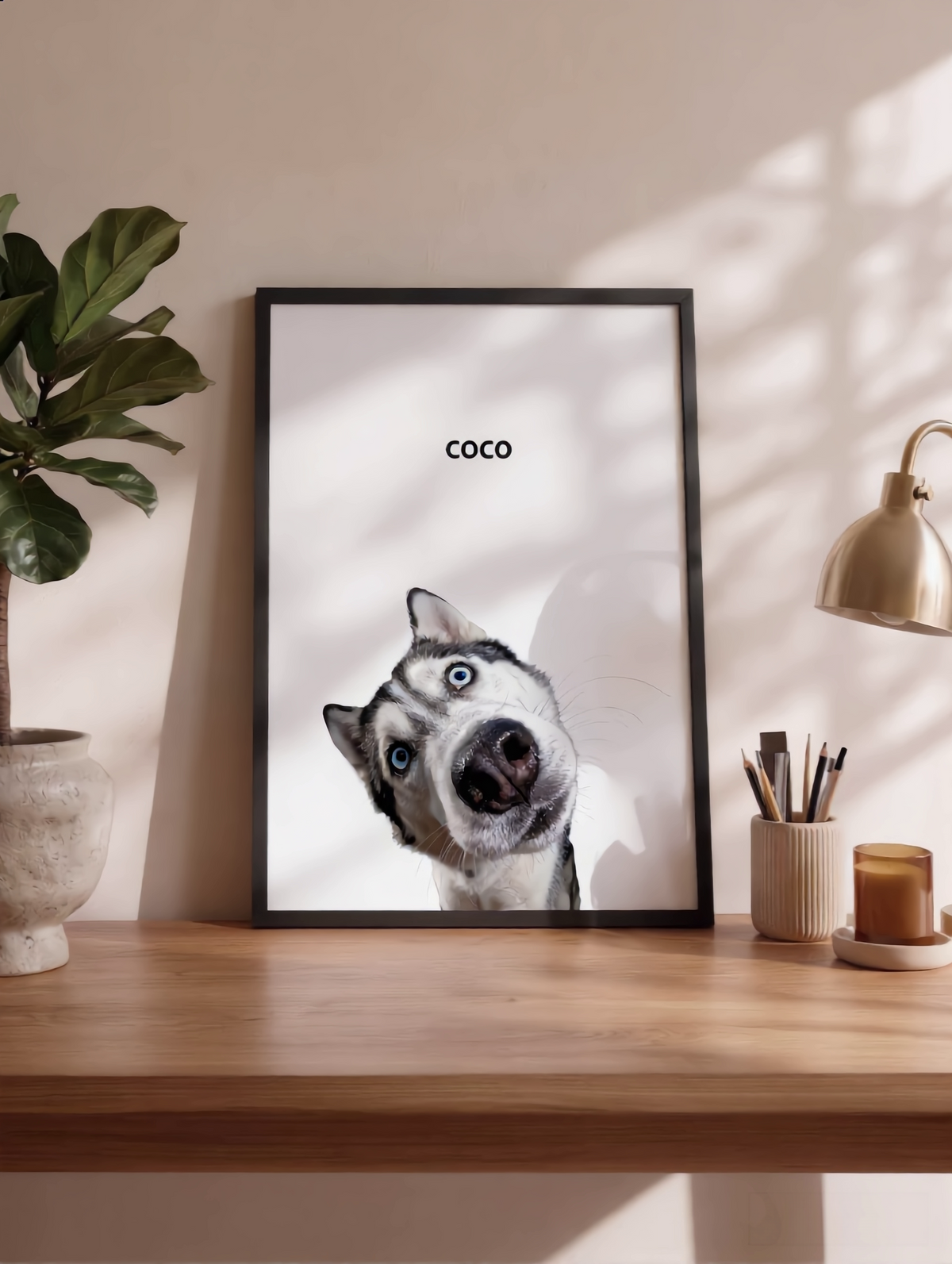 Personalized minimal pet portrait of a husky named Coco in a black frame on a wooden desk.
